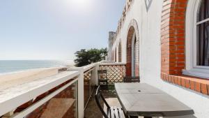 a balcony with a bench and the beach at L Ocean N36 2P2 in La Tranche-sur-Mer