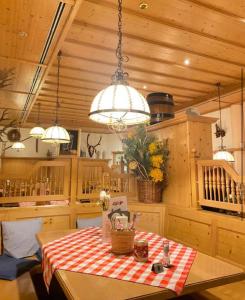 a kitchen with a table with a red and white checkered table cloth at Fichtelgebirgshof in Himmelkron