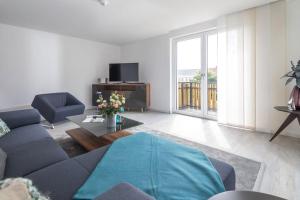 a living room with a couch and a tv at Wohnart - Fewo 8 Wohnambiente in Norderney