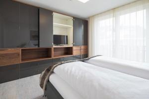 a bedroom with a bed with a tv and a window at Wohnart - Fewo 8 Wohnambiente in Norderney