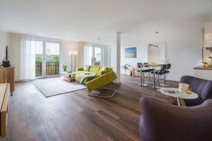 a living room with a yellow couch and a table at Wohnart - Fewo 6 Wohnkultur in Norderney
