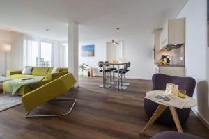 a living room with a couch and a table at Wohnart - Fewo 6 Wohnkultur in Norderney