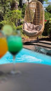 a table with a drink and a chair next to a pool at Hotel Plaza in Milano Marittima