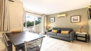 a living room with a couch and a table at Lisa Maria D N38 2P5 in Sari Solenzara