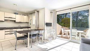 a kitchen and dining room with a table and chairs at Lisa Maria D N38 2P5 in Sari Solenzara