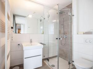a bathroom with a shower and a sink and a toilet at Ferienwohnung Meeresrauschen in Norderney +5 photos