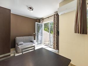 a living room with a couch and a table at Lisa Maria E N60 3P7 in Sari Solenzara