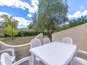 a white table and chairs on a patio at Lisa Maria E N60 3P7 in Sari Solenzara +3 photos