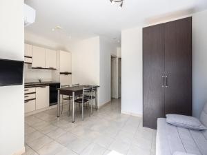 a kitchen and living room with a table and chairs at Lisa Maria E N60 3P7 in Sari Solenzara