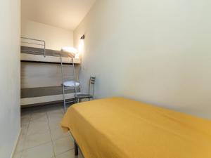 a room with a bed and a bunk bed with a ladder at Lisa Maria E N60 3P7 in Sari Solenzara
