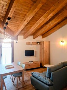 a living room with a table and a couch at Apartamentos Casa Domec in Castejón de Sos +4 photos