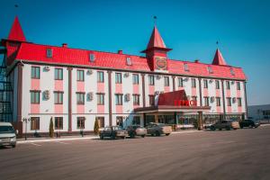 a large building with cars parked in front of it at Turist Hotel in Saratov