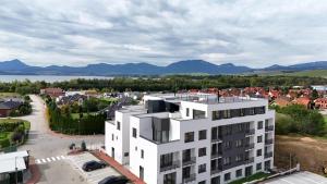 an aerial view of a white building in a city at Lúka Palúdzka in Liptovský Mikuláš