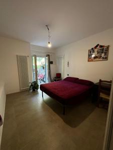 a bedroom with a large red bed in a room at Villetta Brasi in Celle Ligure