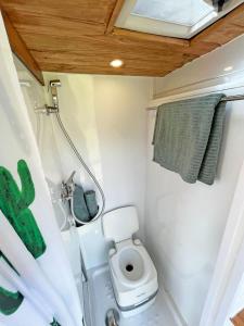a small bathroom with a toilet in a trailer at Tenerife Stylish Camper Van with Bathroom in Arona