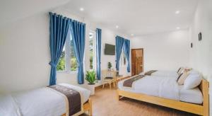 En eller flere senge i et værelse på May Trang Villa