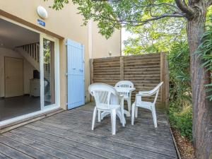 a patio with two chairs and a table on a deck at D du Ventoux D N55 3P6 in Aubignan