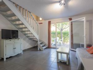 a living room with a staircase and a television at D du Ventoux D N55 3P6 in Aubignan