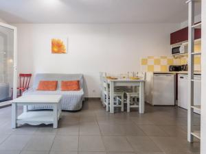 a kitchen and a living room with a couch and a table at D du Ventoux D N55 3P6 in Aubignan +3 photos