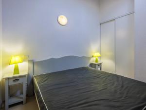 a bedroom with a bed and two lamps on two tables at D du Ventoux D N55 3P6 in Aubignan