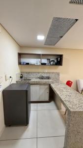 a kitchen with a counter and a counter top at Imperial Flat orla de tambáu in João Pessoa