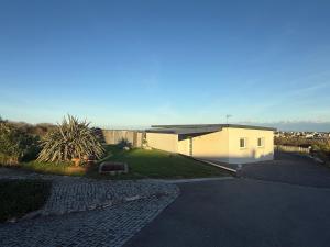 a house with a driveway in front of it at Chez Tristan in Plouguerneau