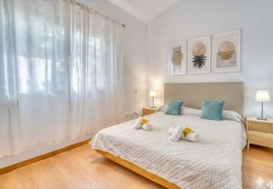 a bedroom with a bed with towels on it at Ideal Property Mallorca - Villa Feel Good in Alcudia