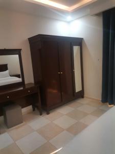 En eller flere senge i et værelse på شقق مزون للشقق المخدومة