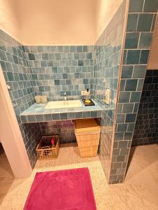 a bathroom with a sink and a blue tiled wall at Naturerlebnis direkt am Traumpfad in Andernach +26 photos