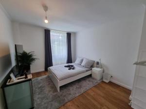 a bedroom with a bed and a television in it at Süße Marie 4 in Karlsruhe