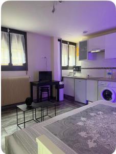 a living room with a kitchen with purple lighting at Studio cosy et calme à Garches in Garches +10 photos
