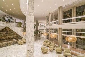 a lobby of a hotel with chairs and a staircase at Maspalomas Princess in Maspalomas +110 photos