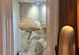 a glass cabinet with a fish on a wall at GAJOs HOUSE in Thanh Xuân +15 photos
