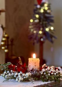 una candela seduta sopra un tavolo con dei fiori di Apartament Pers - ciepło, cisza i klimat a Szczawno-Zdrój Altre 28 foto