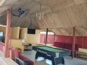 a room with a ping pong table in it at 6A Resort in Owerri