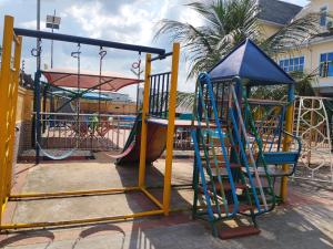 a playground with a slide and a swing at 6A Resort in Owerri +6 photos