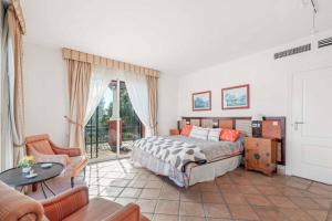 a bedroom with a bed and a living room at Villa Oceana in Manilva +21 photos