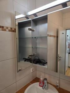 a bathroom with a sink and a mirror at Inselpause in Wittdün +17 photos