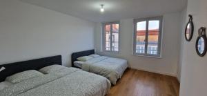 En eller flere senge i et værelse på Le Gîte des Travailleurs