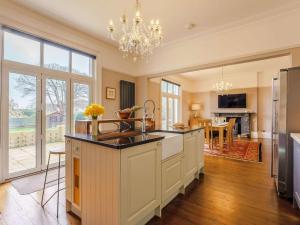 a kitchen with a large island in the middle at 5 Bed in Sandown oc-87008 in Sandown