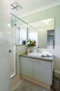 a bathroom with a sink and a shower at Queens Residence Perth Western Australia in Perth +38 photos