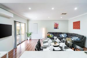 a living room with a couch and a table at Queens Residence Perth Western Australia in Perth