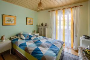 a bedroom with a bed and a large window at Ferienwohnung in Lichtenfels mit 125 Quadratmeter in Lichtenfels +21 photos