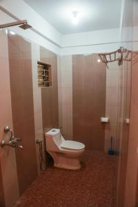 a bathroom with a pink toilet and a shower at Dreamcatcher House & Hostel at Arambol Beach in Arambol