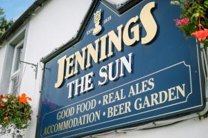 a sign for a restaurant on the side of a building at Sun Inn in Pooley Bridge