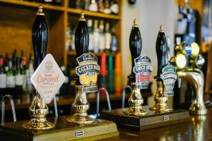 a bar with three bottles of beer on a counter at Sun Inn in Pooley Bridge
