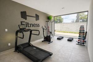 a gym with two exercise bikes and a treadmill at Cantinho do Sossego in João Pessoa