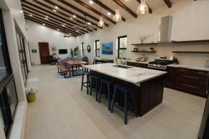 a large kitchen with a large island in the middle at Sunset Oasis Waterfront in Maya Beach