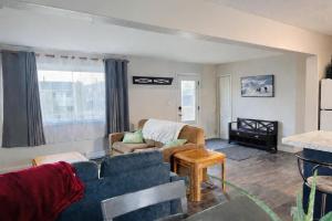 a living room with a couch and a table at Mountain Joy Getaway in Valemount