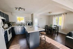 a kitchen and dining room with a table and chairs at Mountain Joy Getaway in Valemount